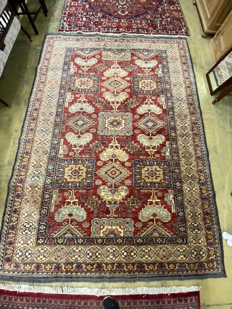 A Caucasian design red ground carpet, 310 x 228cm